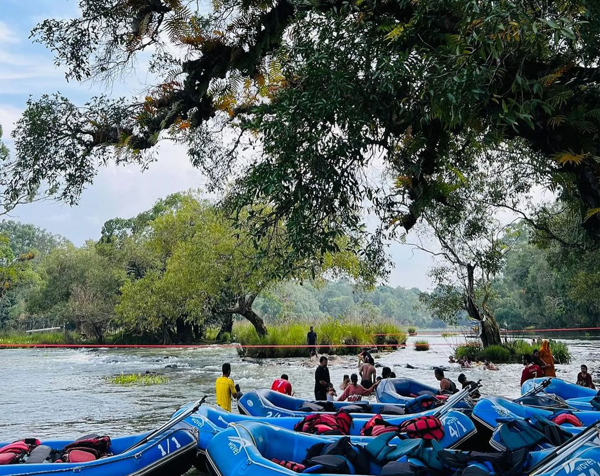 Tourists bathing an elephant in the Kaveri river at Dubare Elephant Camp Coorg