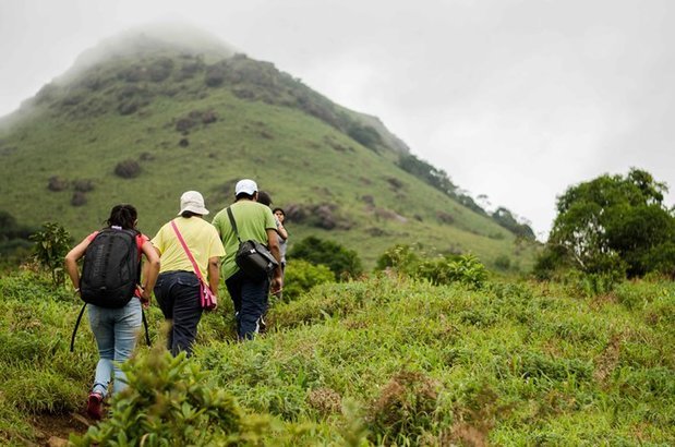 Trekker enjoying panoramic view from Brahmagiri peak in Coorg
